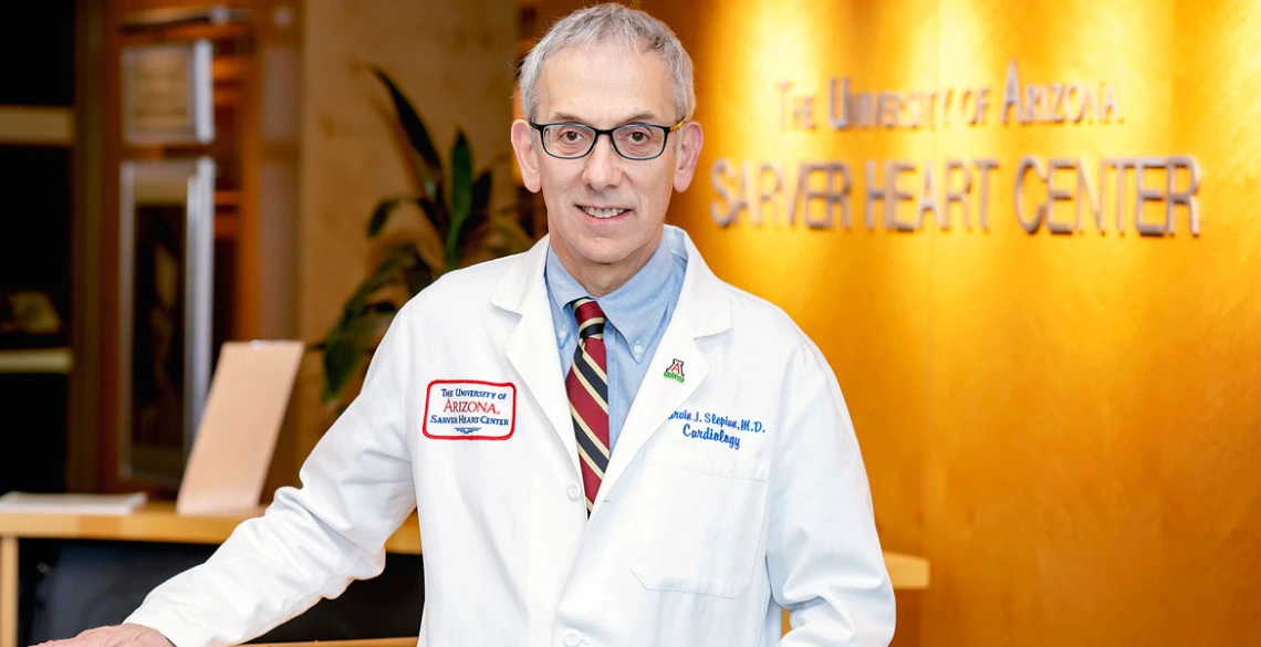 Marvin J. Slepian stands in front of a Sarver Heart Center sign wearing a lab coat