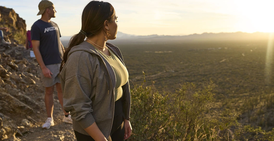 Two students gaze at the desert landscape