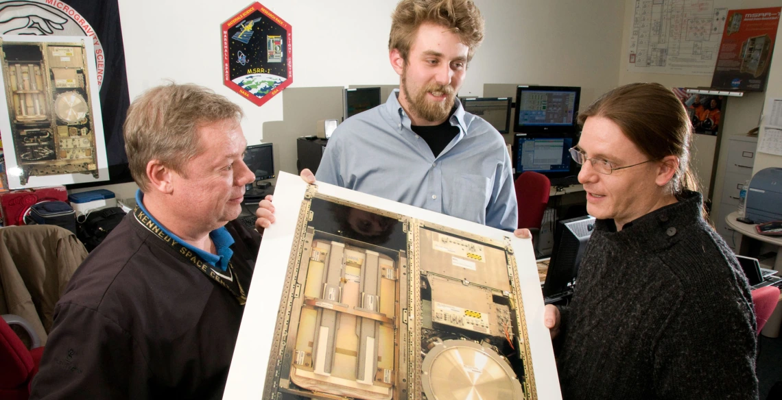 engineers examine test equipment