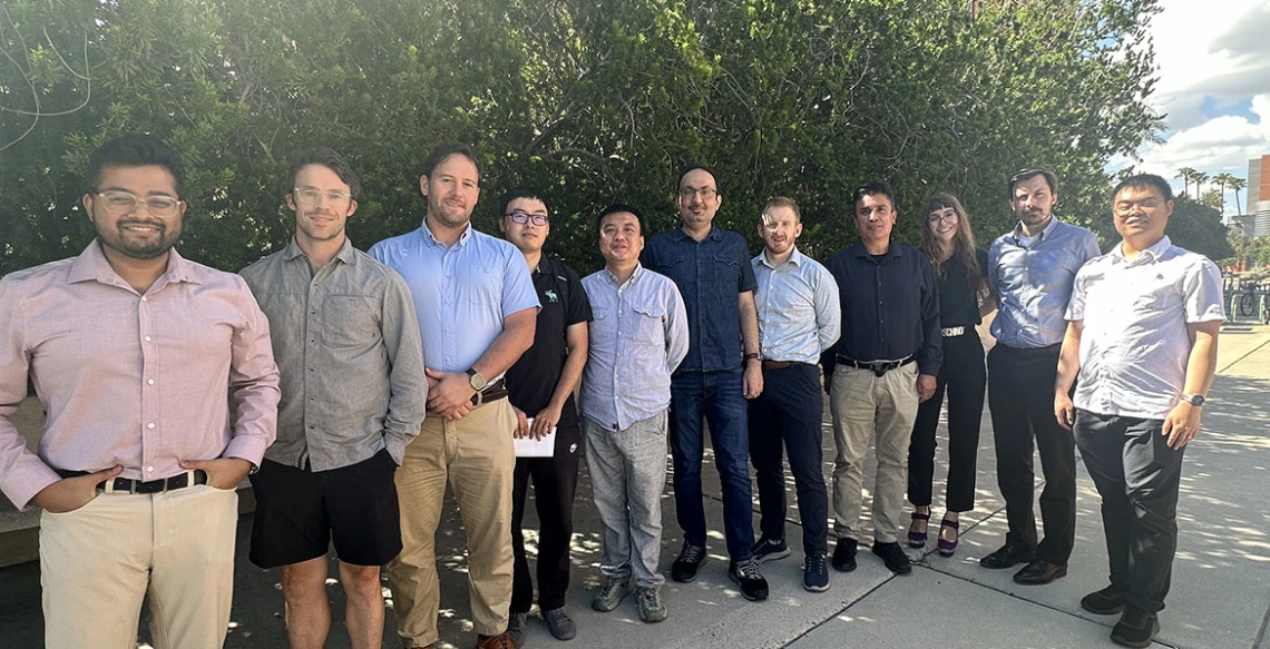 a large group of instructors poses outdoors