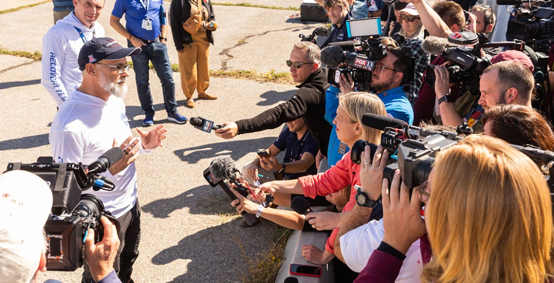 a news conference at the sample landing site