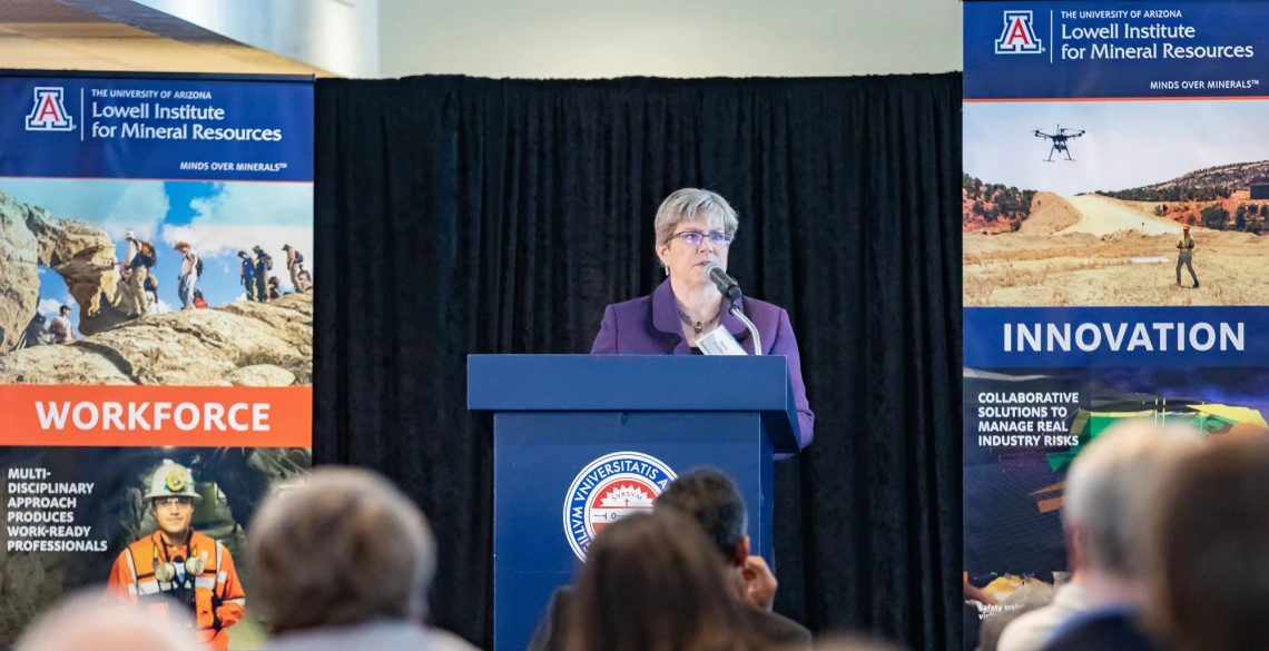 Mary Poulton speaking from podium