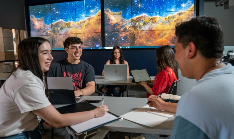 Students collaborate in a high-tech makerspace.