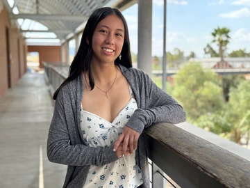 A woman with dark hair poses for a photo.