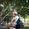 A cyclist riding outdoors models the device