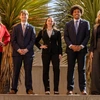 students in suits pose for a photo