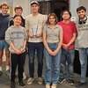 Students in different colored shirts pose for a photo.