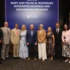 A mix of people in professional clothing stand in front of a sign reading "The Mary and Felipe M. Rodriguez Integrated Business and Engineering program."