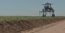 A high-tech tractor-type vehicle moves across a field.