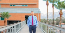 David Hahn stands on the exterior footbridge between the two sections of the Aerospace & Mechanical Engineering Building.