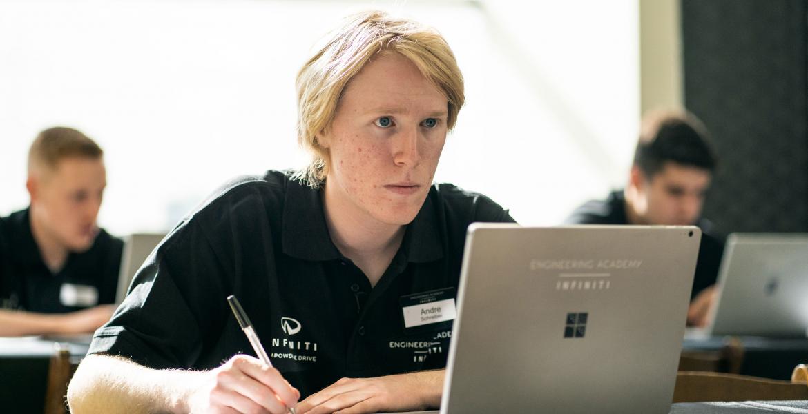 Andre Schreiber looking intently at a laptop screen.