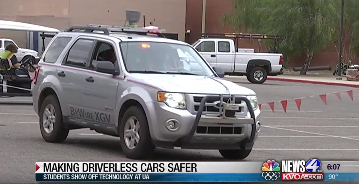 Screencap of a newscast with a car driving across the frame and a lower-third caption that reads, 