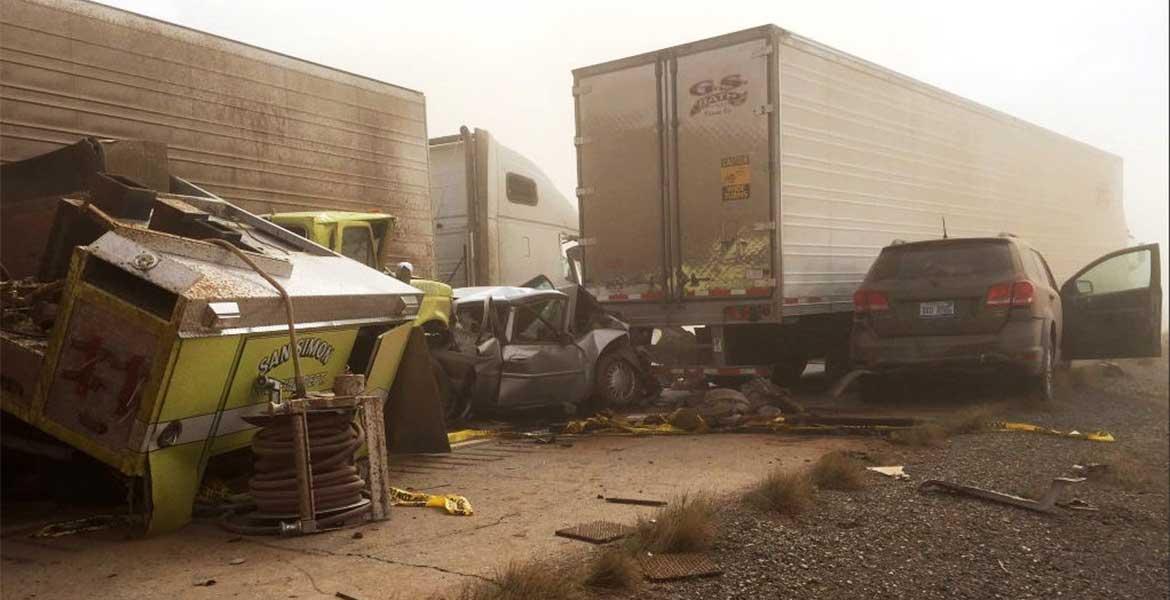 A multicar accident on a dusty roadside