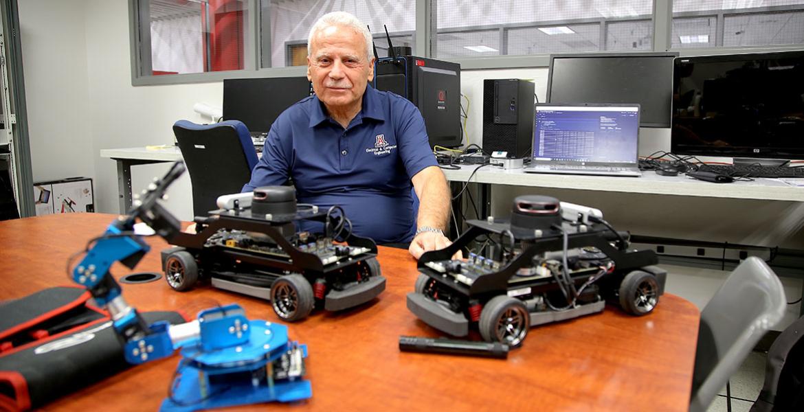 Salim Hariri in his lab with autonomous vehicles