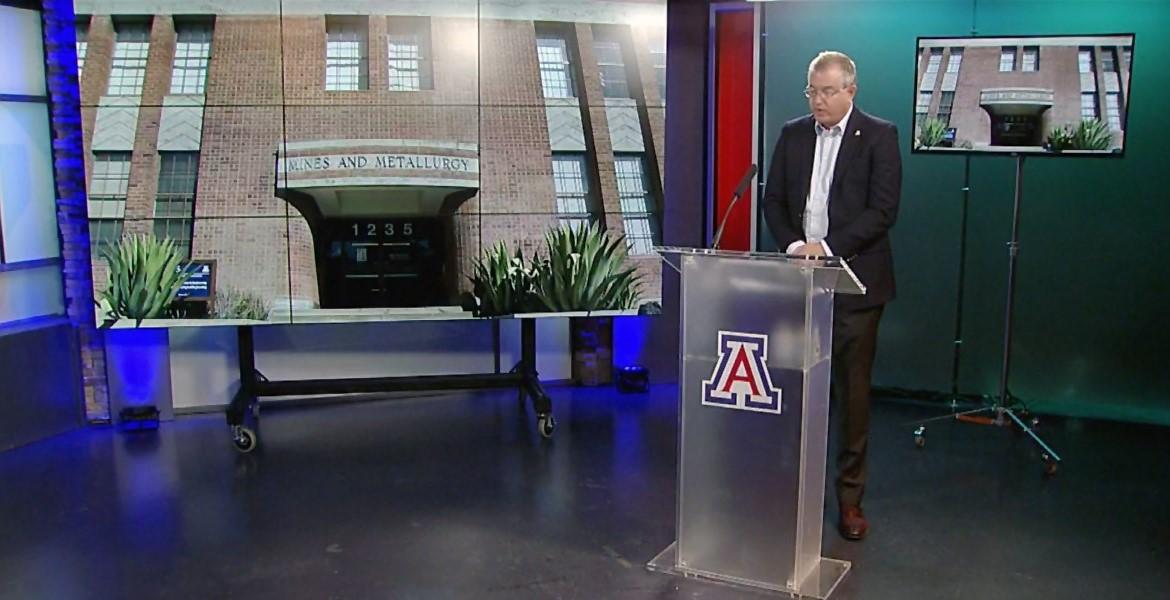 Screenshot of a video in which David W. Hahn stands at a podium speaking, with an image of the Old Engineering building behind him.