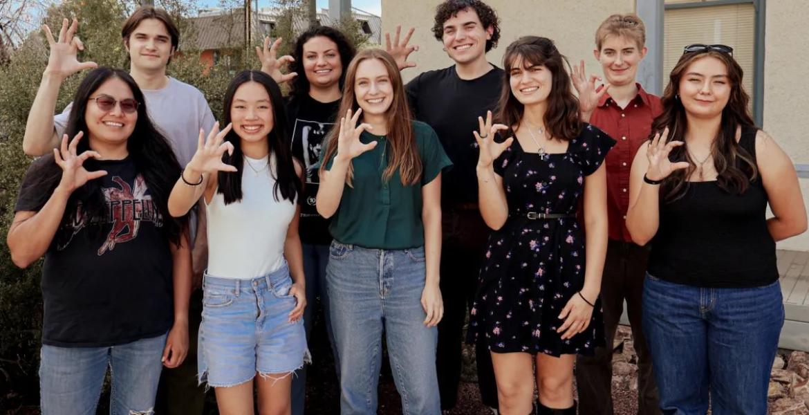 nine students pose outdoors