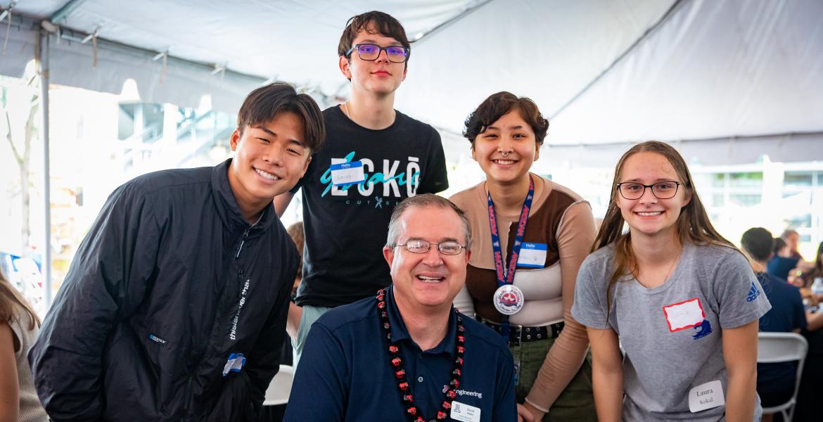 Dean David Hahn poses for a photo with four incoming engineering students
