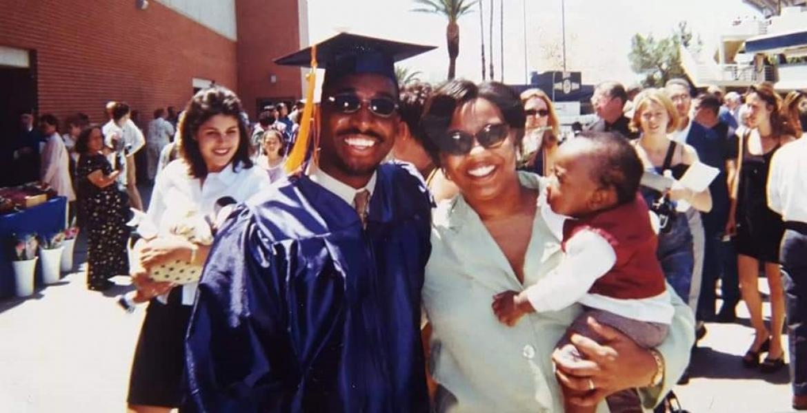 Brian Mushimba with his wife & son at his UA graduation.