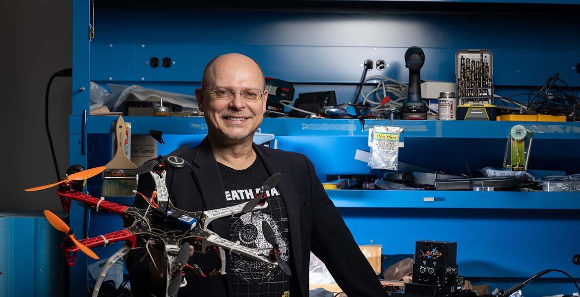 Wolfgang Fink poses with a planetary rover