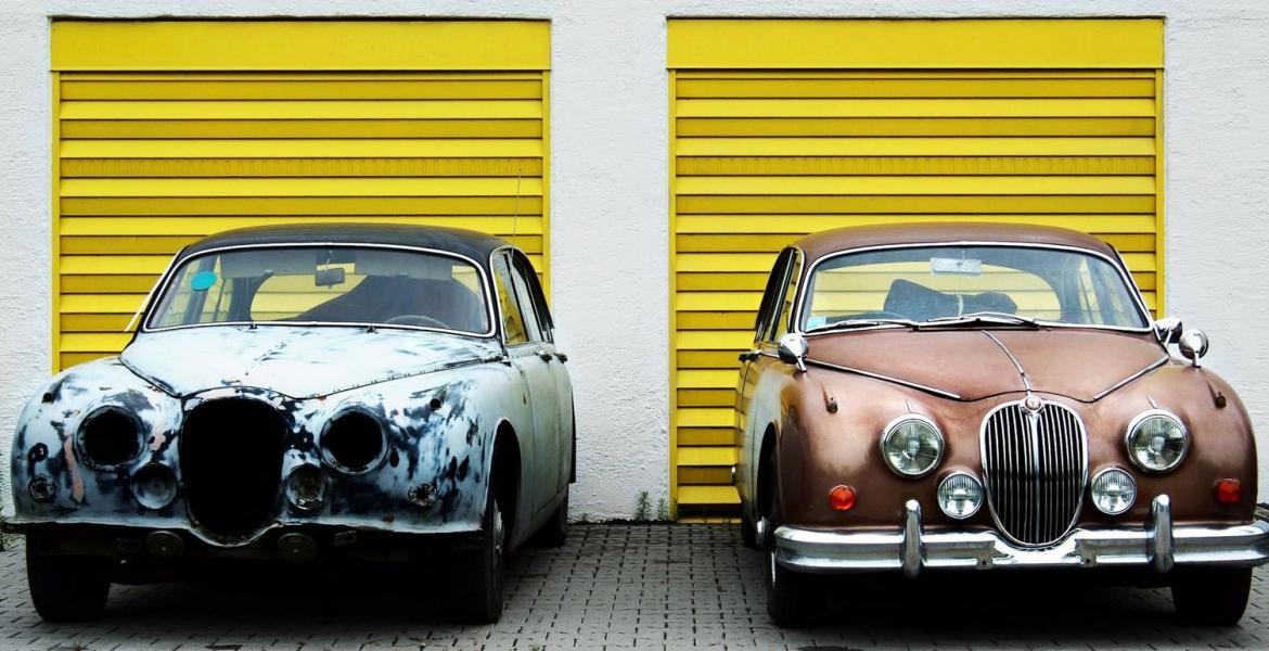 photo of old car next to new car