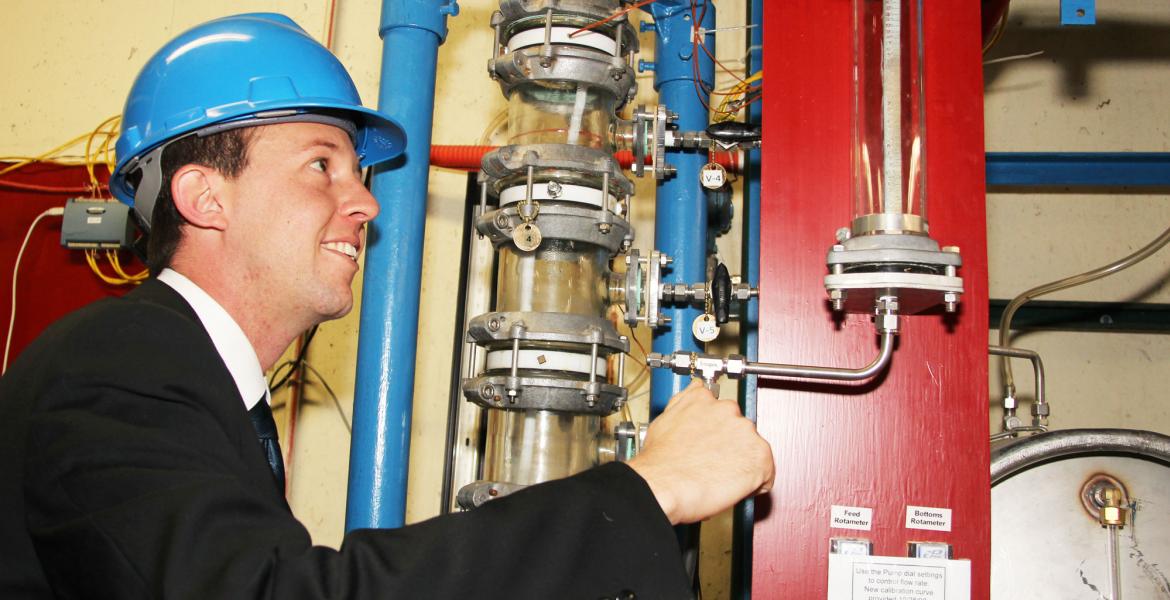 man inspecting water pipes