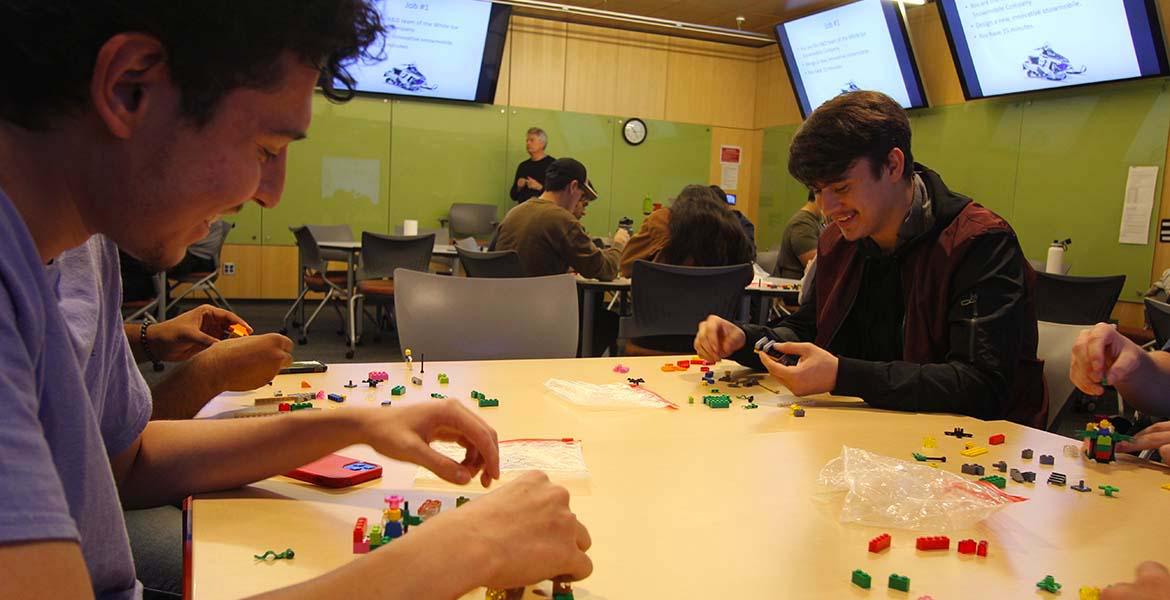 Students work with Lego blocks in a classroom