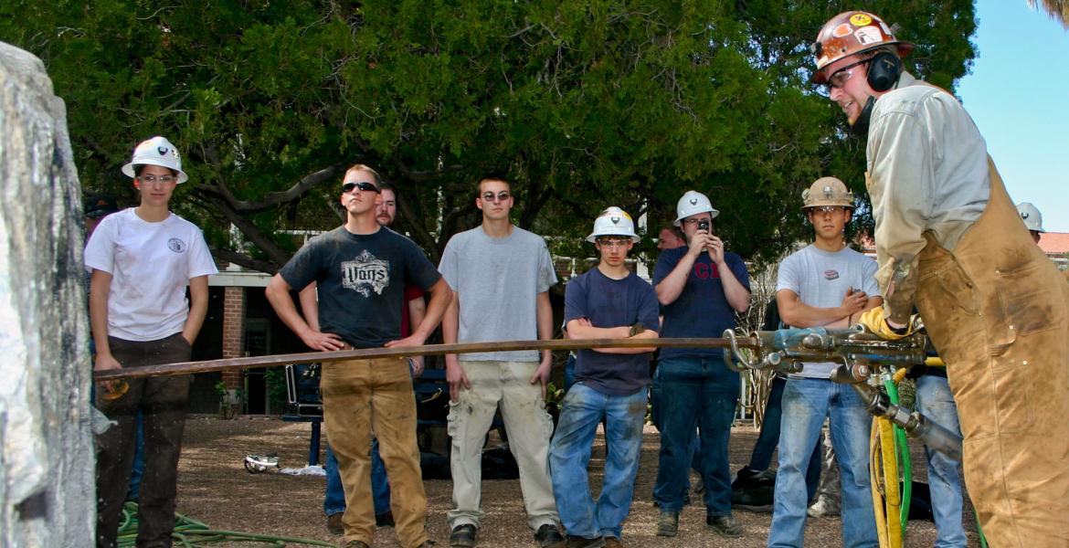 mining engineering students drilling rocks