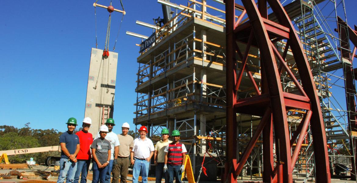 engineers standing next to giant earthquake test rig