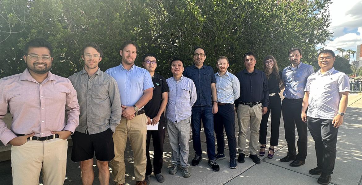 a large group of instructors poses outdoors