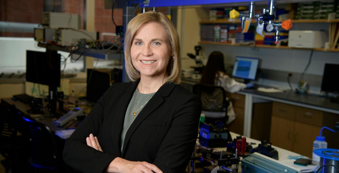 Jennifer Barton, professionally posed and smiling in a biomedical lab.