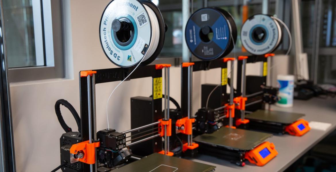 three 3D printers in a lab