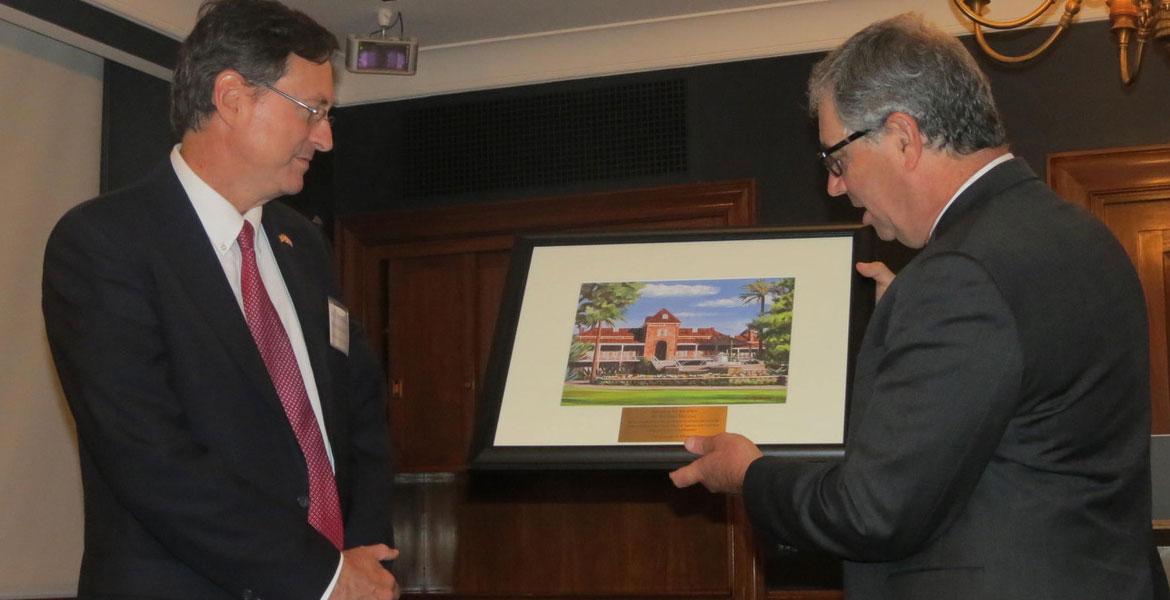 Jeff Goldberg hands plaque to Roman Macaya