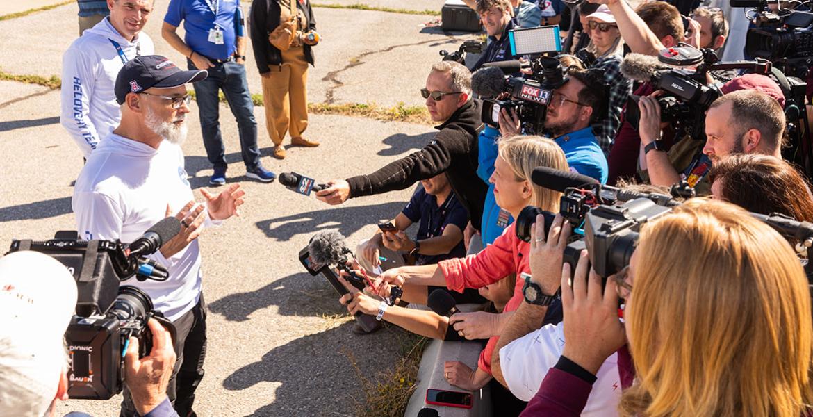 a news conference at the sample landing site