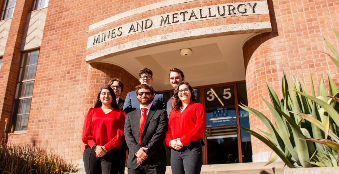 Five students stand on the front steps of the Mines and Metallurgy building.