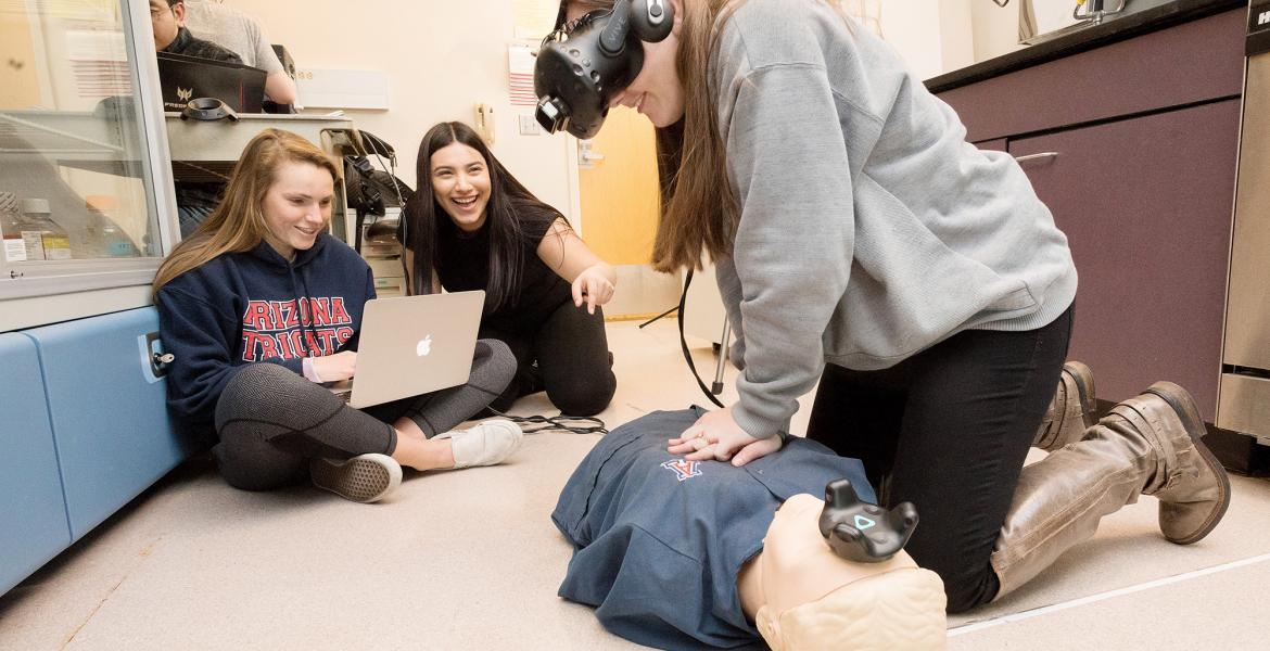 UA engineering students fine-tune their virtual reality system for CPR training after hours on the floor of a lab at the Sarver Heart Center.