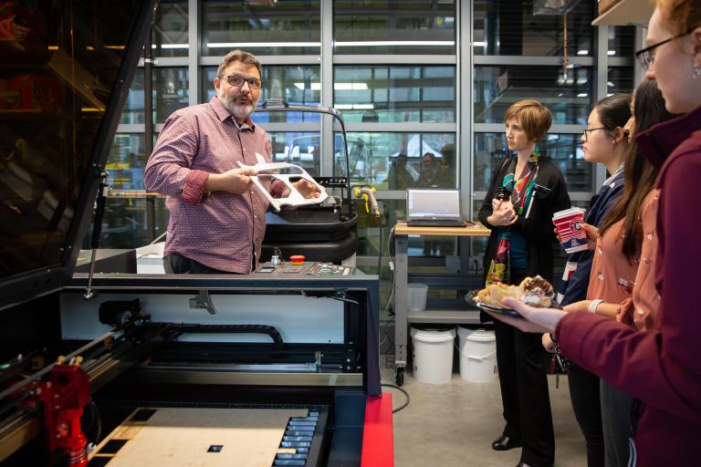 Biomedical associate professor Urs Utzinger shows a group some of the lab's equipment.