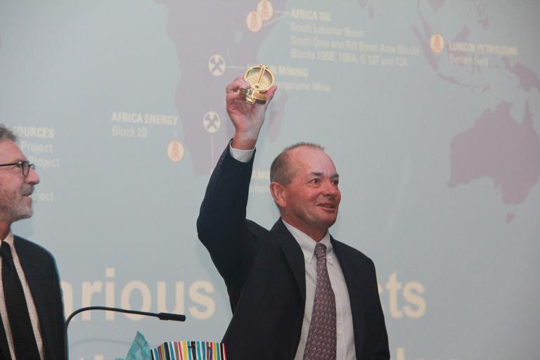 Lukas H. Lundin lifts his commemorative compass after delivering the 2016 Lacy Lecture for the Department of Mining and Geological Engineering