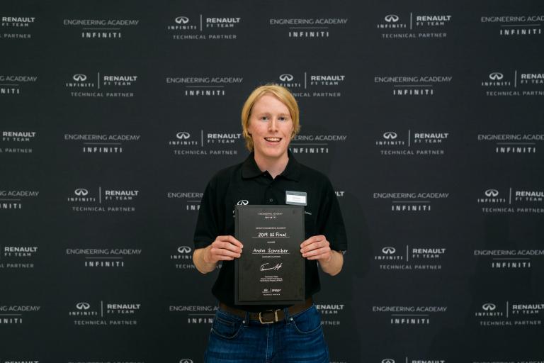 Andre Schreiber holding a plaque.