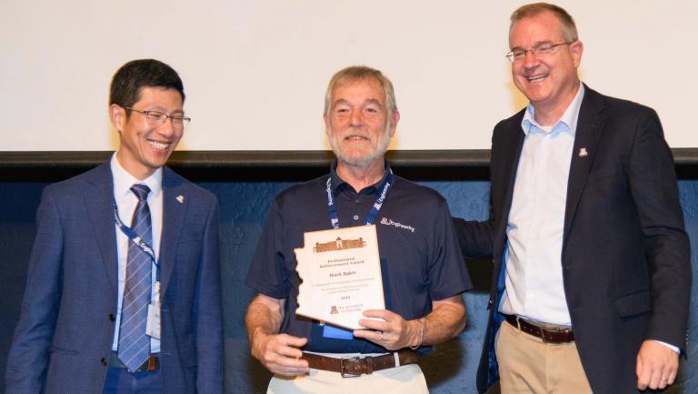 Baker poses with the electrical and computer engineering department head and the college's dean.