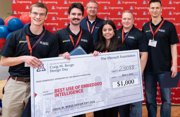 6 people pose with a large prize check