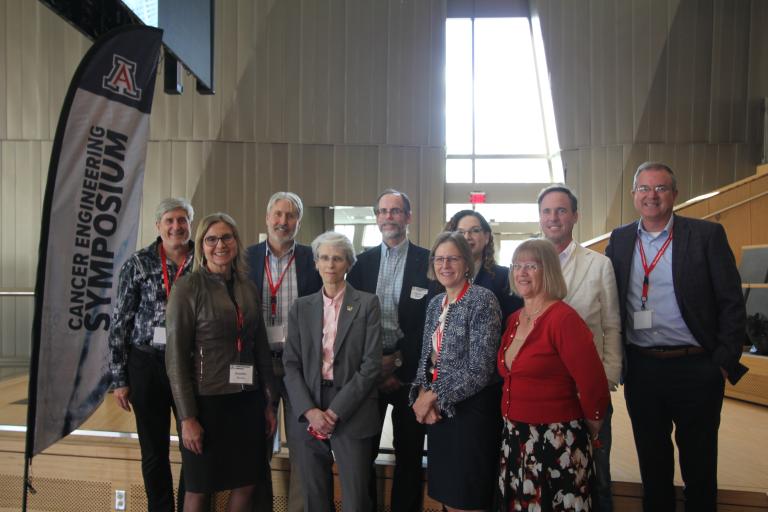 Speakers stand together in the conference venue