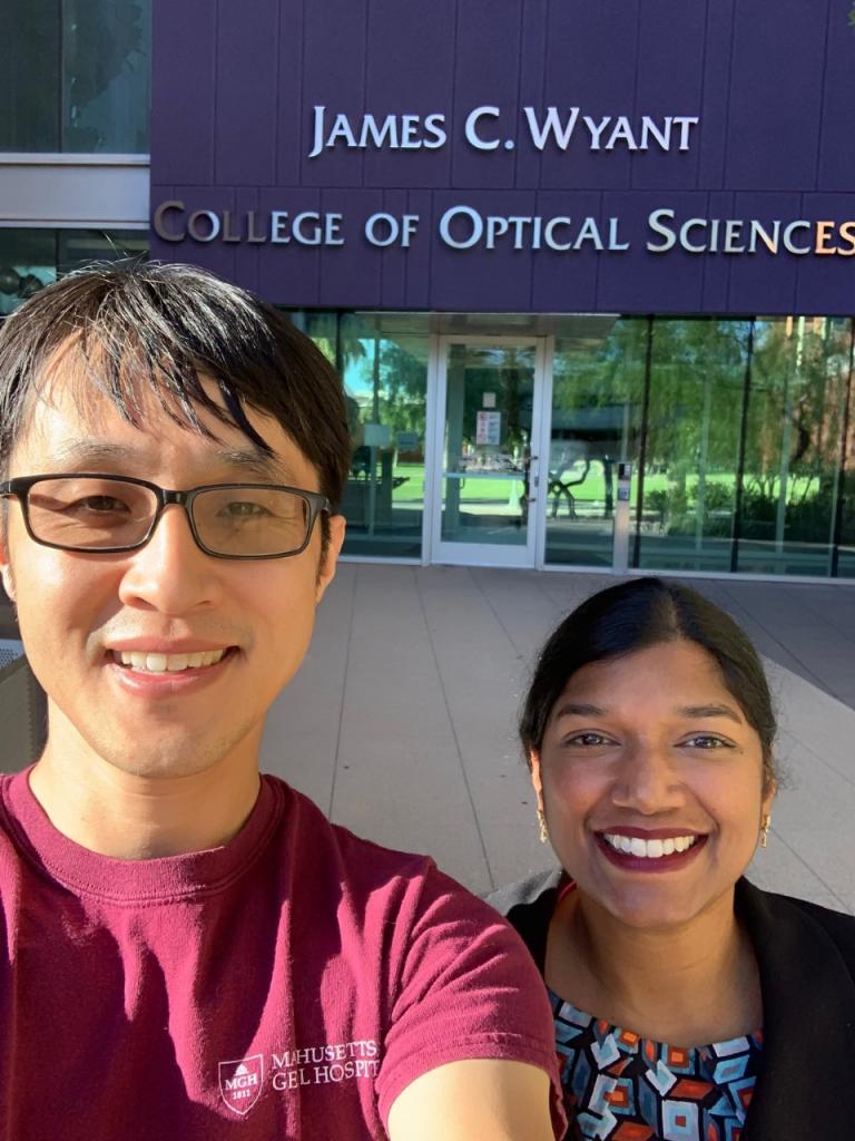 Two people taking a selfie in front of the James C. Wyant College of Optical Sciences building.