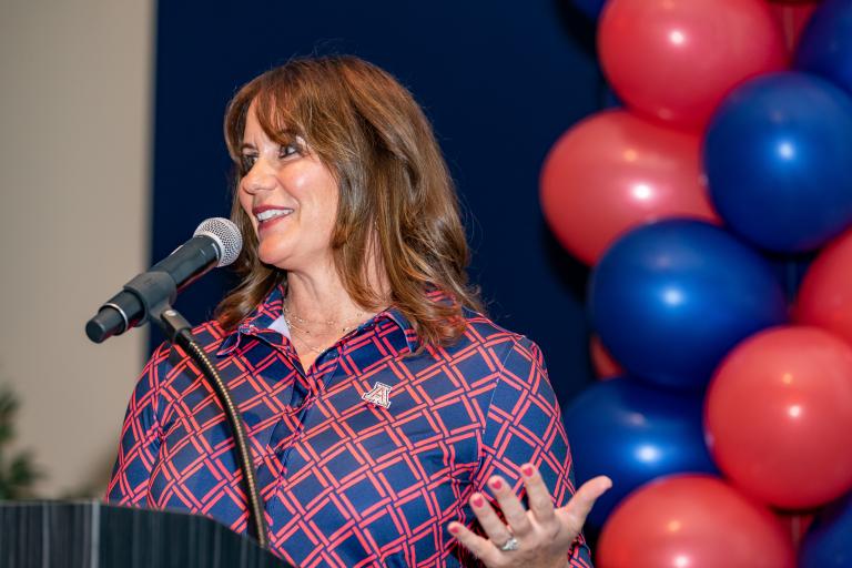 Susan Gray speaking at a podium