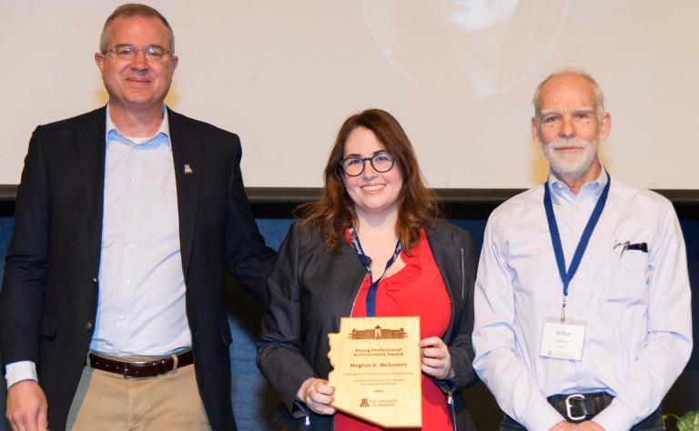 Meghan McGovern poses for her award with the college's dean and the biomedical engineering department head.