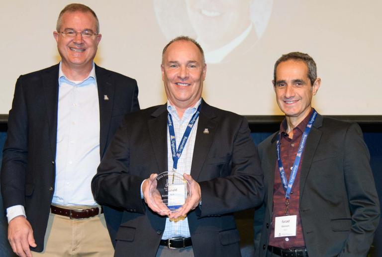 Rich poses with the aerospace and mechanical engineering department head and the college's dean.