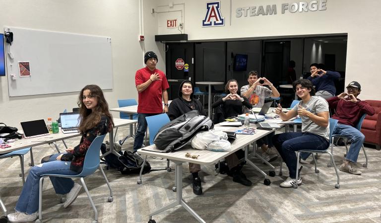 a group of students meets at a table in the STEAM FORGE office