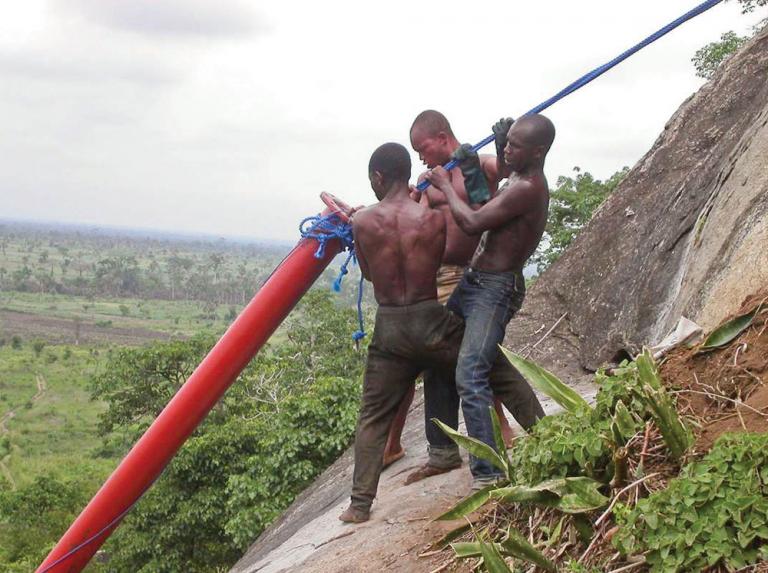 workers installing pipeline