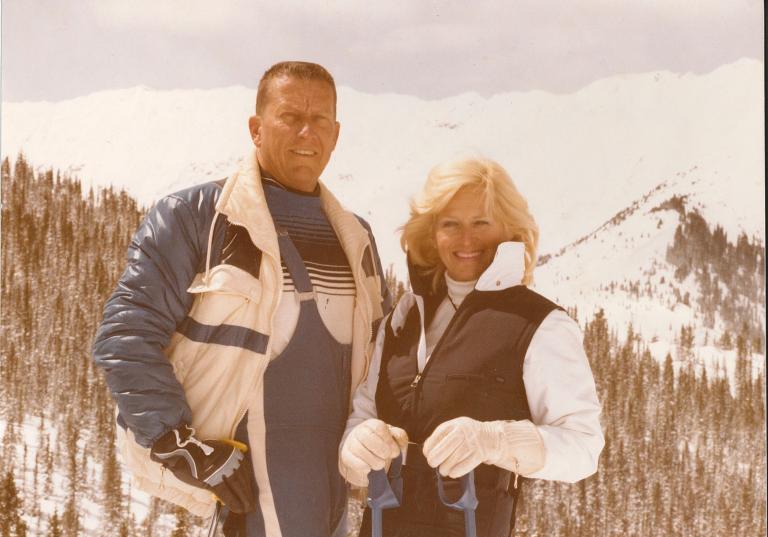Craig and Nancy Berge on skis atop a snowy mountain