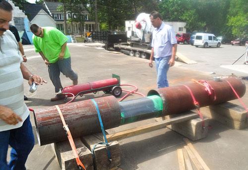 workers fixing pipe