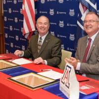 Edward Ayer and David Hahn sign the Education Partnership Agreement.